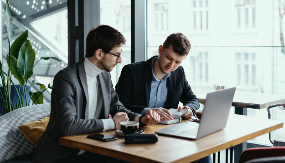 Two young businessman having a successful meeting at restaurant.